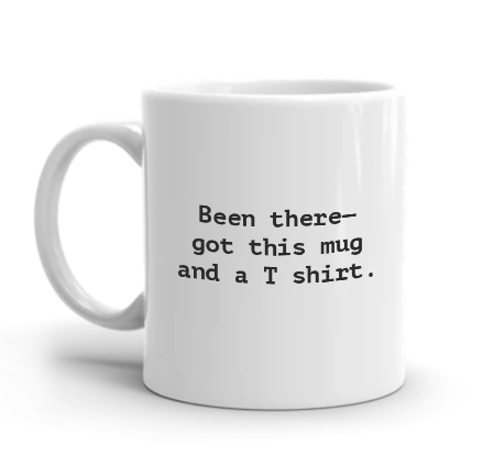 A plain white mug with lettering on iy